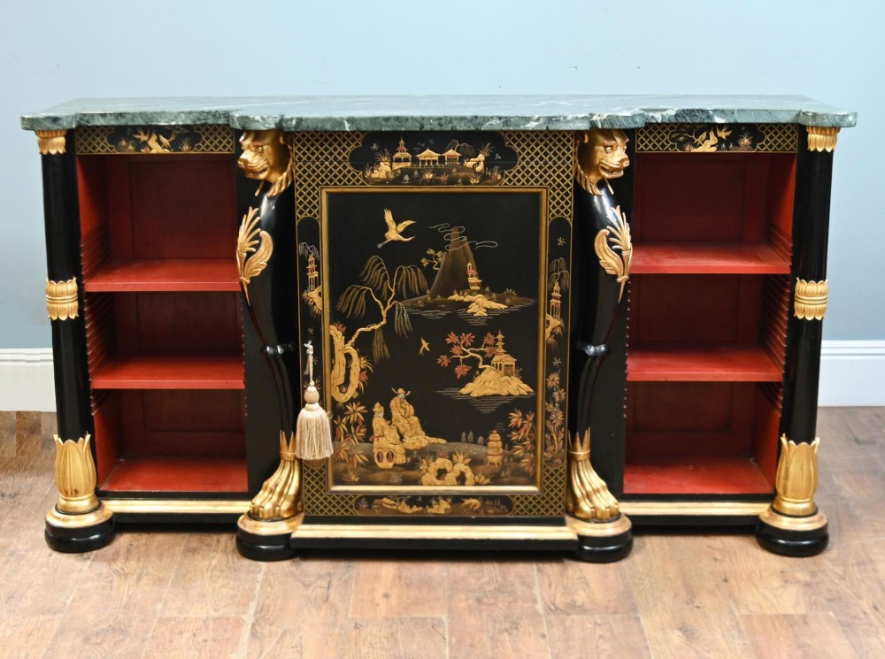 A Regency Revival side cabinet featuring a green marble top, a central black lacquer door decorated with gilded Chinoiserie artwork, and flanking open shelves with red interiors.