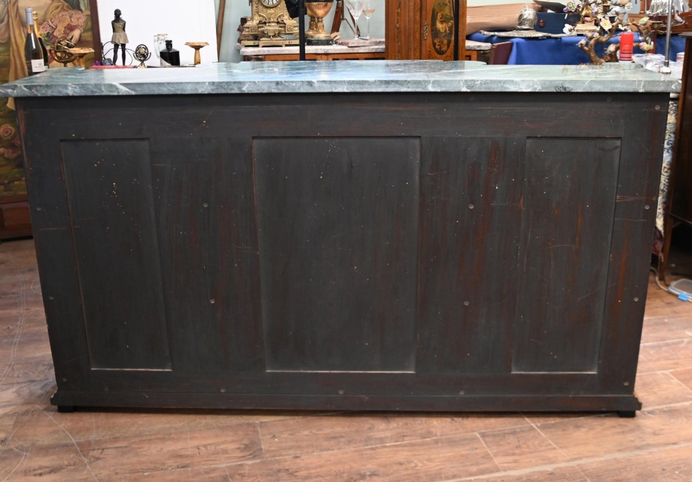 A Regency Revival side cabinet featuring a green marble top, a central black lacquer door decorated with gilded Chinoiserie artwork, and flanking open shelves with red interiors. View VI