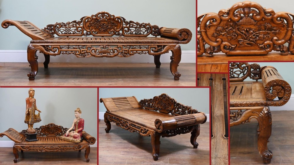 An intricately hand-carved warm brown hardwood Chinese opium bench featuring a slatted seat, elevated recline end, and pierced scrollwork along the backrest. View X