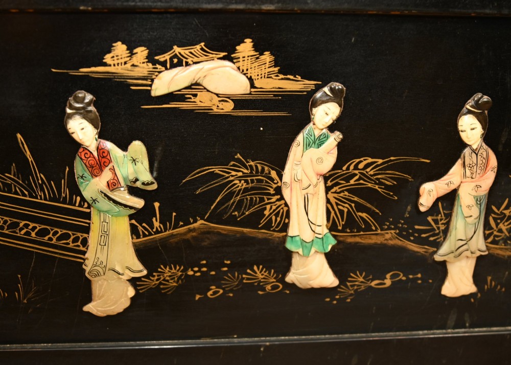 A black lacquered rectangular wooden chest embellished with raised soapstone figures and landscape scenes, fitted with an etched brass lock plate. View III