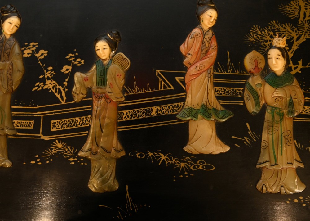 A black lacquered rectangular wooden chest embellished with raised soapstone figures and landscape scenes, fitted with an etched brass lock plate. View VIII