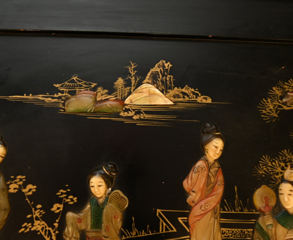 A black lacquered rectangular wooden chest embellished with raised soapstone figures and landscape scenes, fitted with an etched brass lock plate. View IX