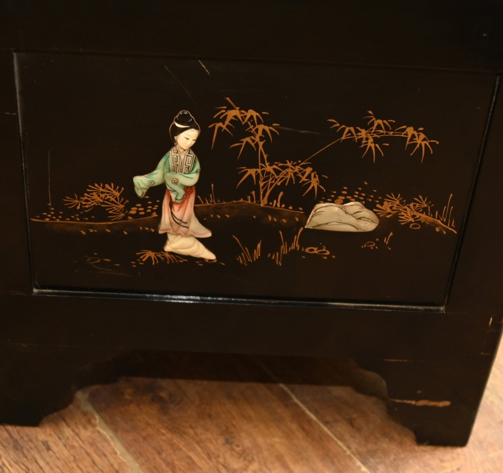 A black lacquered rectangular wooden chest embellished with raised soapstone figures and landscape scenes, fitted with an etched brass lock plate. View XII
