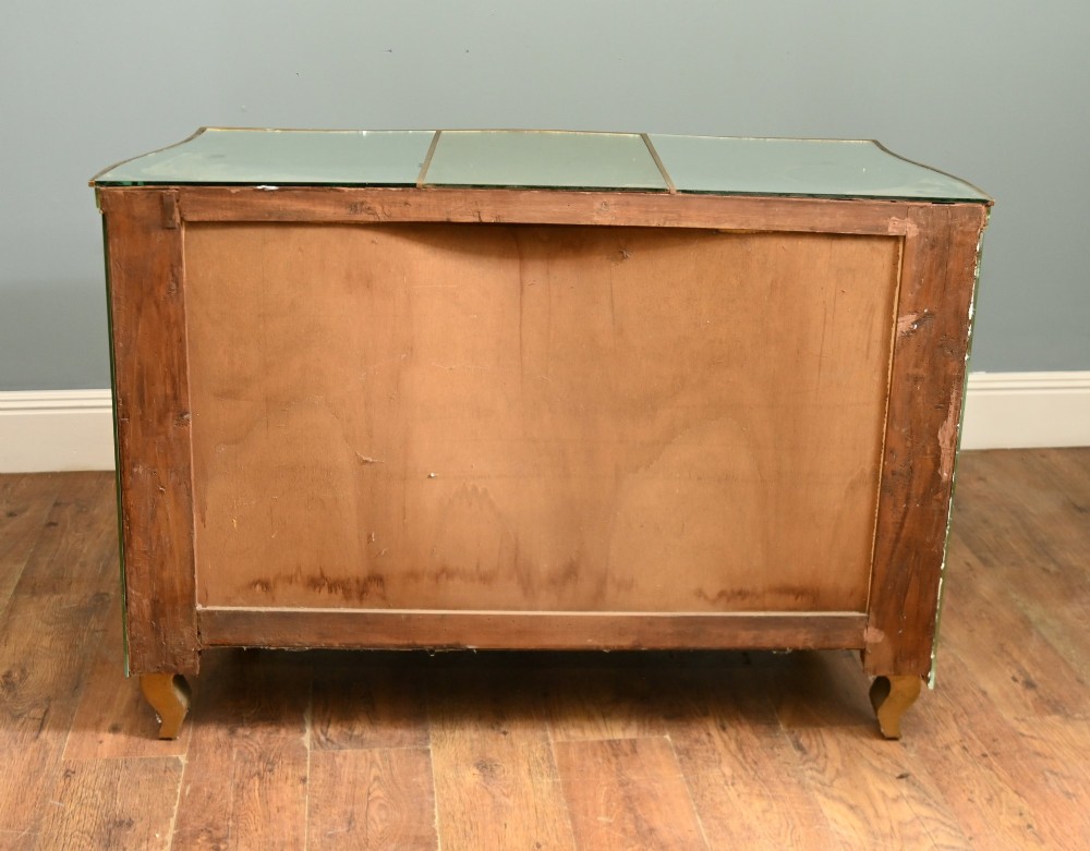 An Art Deco mirrored chest of drawers featuring segmented glass panelling, four drawers with geometric brass handles, and a shaped lower apron. View IX