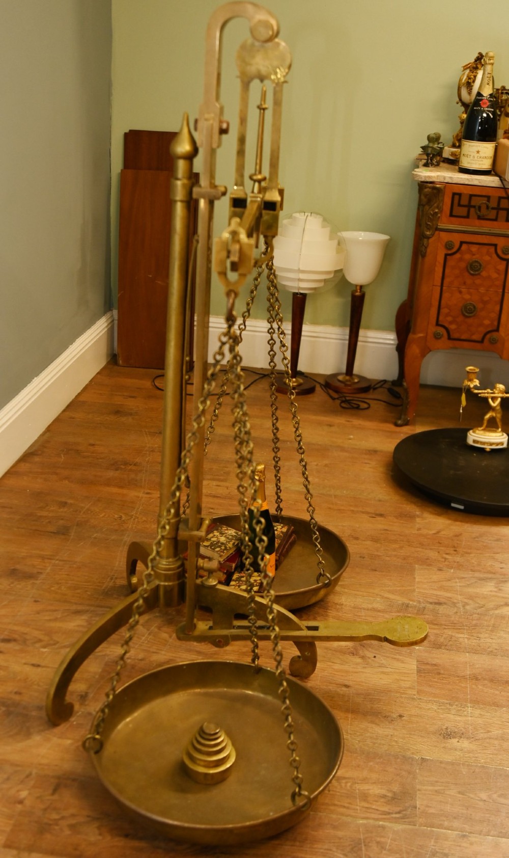 A nineteenth-century brass Avery balance scale featuring a tall central pillar, horizontal beam, twin hanging circular pans, and nested counterweights. View XIII