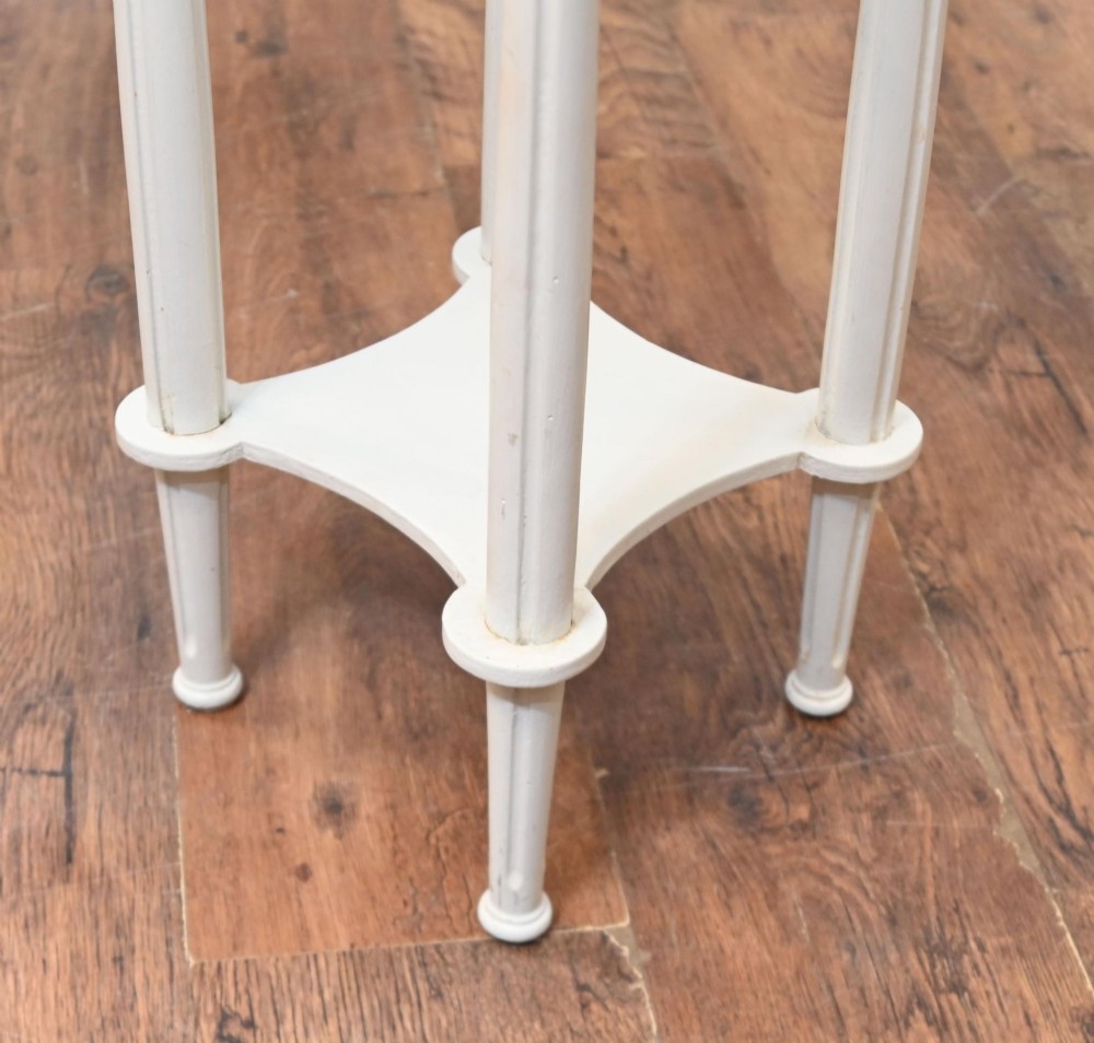A white painted tall French pedestal stand featuring four fluted legs, gilt brass mounts, a lower tier, and a shaped variegated marble top with a brass gallery. View VI