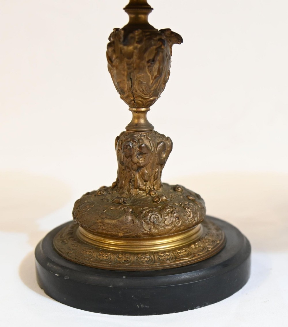 A pair of late 19th-century French ormolu classical tazzas with relief-cast circular dishes on decorative stems mounted on round black marble bases. View IX