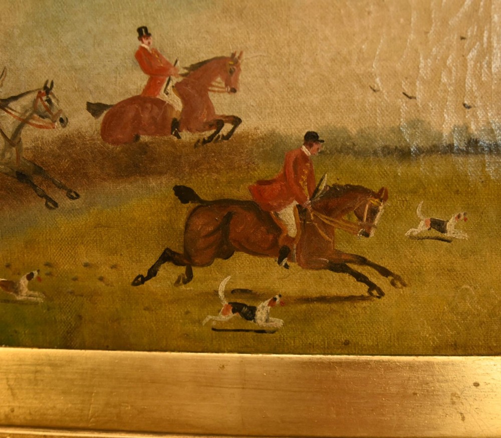 A pair of horizontal antique Victorian oil paintings in ornate gold gilt frames depicting horseback riders and hounds in a field. View X