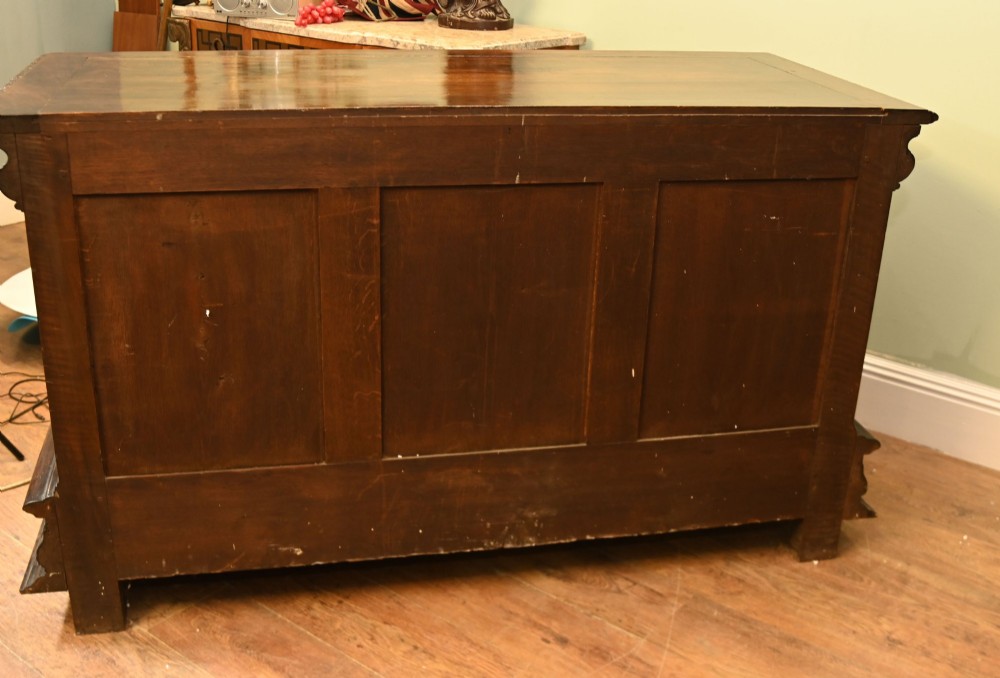 A carved dark walnut coffer featuring a central relief scene flanked by carved corner figures and decorative egg-and-dart base mouldings. View XIV