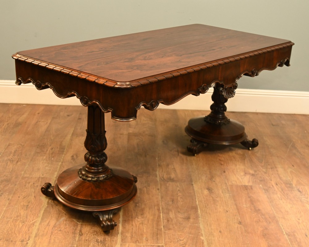 A William IV mahogany library table with a carved apron, shell detail, twin pedestal end supports, and scroll feet. View III