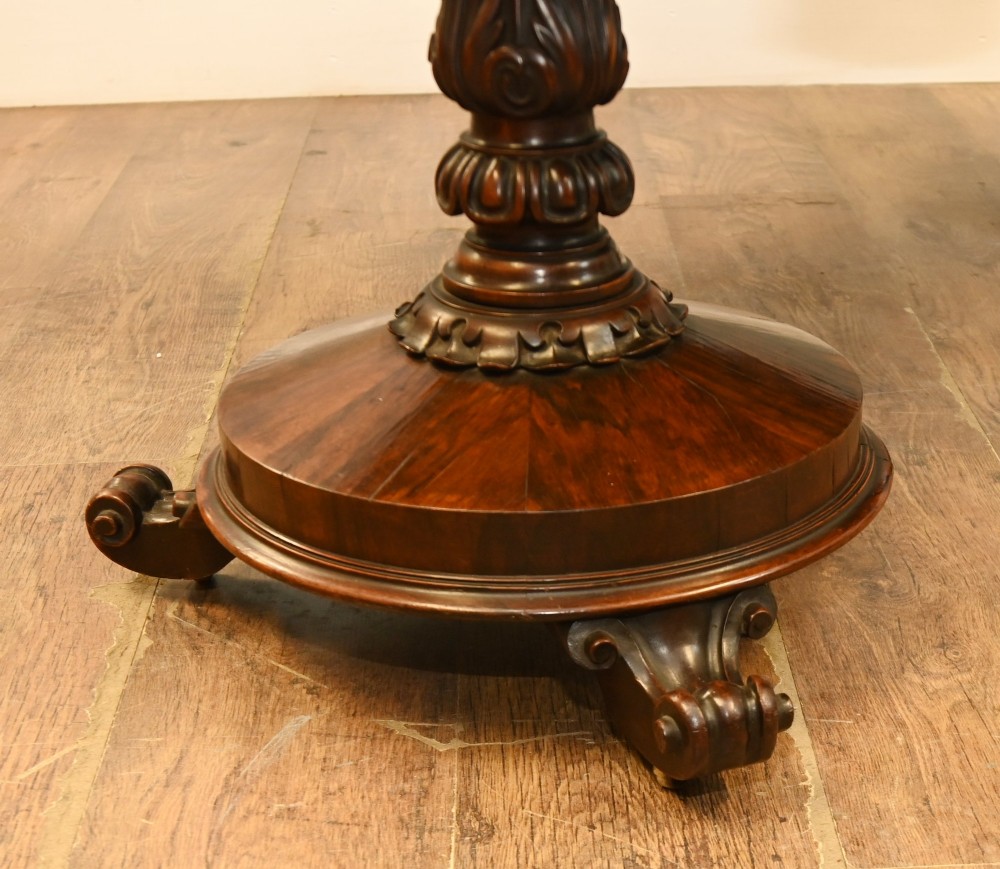 A William IV mahogany library table with a carved apron, shell detail, twin pedestal end supports, and scroll feet. View V