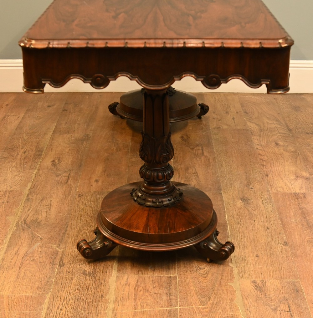 A William IV mahogany library table with a carved apron, shell detail, twin pedestal end supports, and scroll feet. View VII