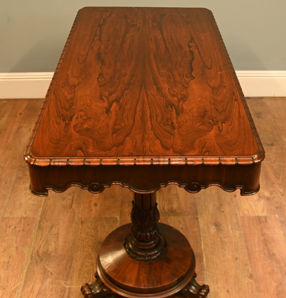 A William IV mahogany library table with a carved apron, shell detail, twin pedestal end supports, and scroll feet. View VIII