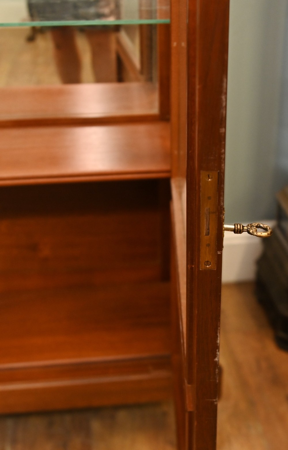 A French Directoire style mahogany vitrine cabinet featuring a single glazed door, fluted corner pilasters, brass line inlays, tapered turned feet, and a marble top surface. View VII