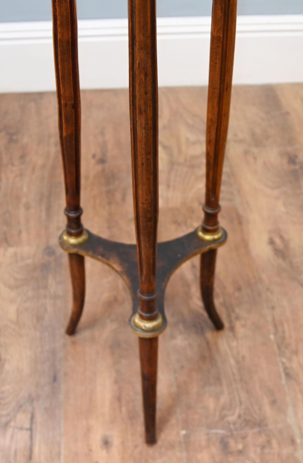 A French Louis XVI style pedestal stand featuring a circular marble top with a pierced brass gallery, supported by three fluted legs and a lower tier. View V