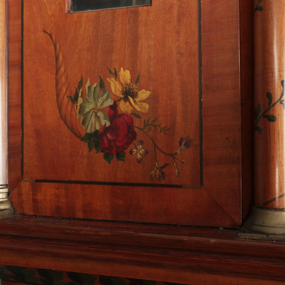 An antique Scottish painted satinwood longcase clock with an arched moonphase dial, brass finials, and neoclassical floral painted panels. View IV