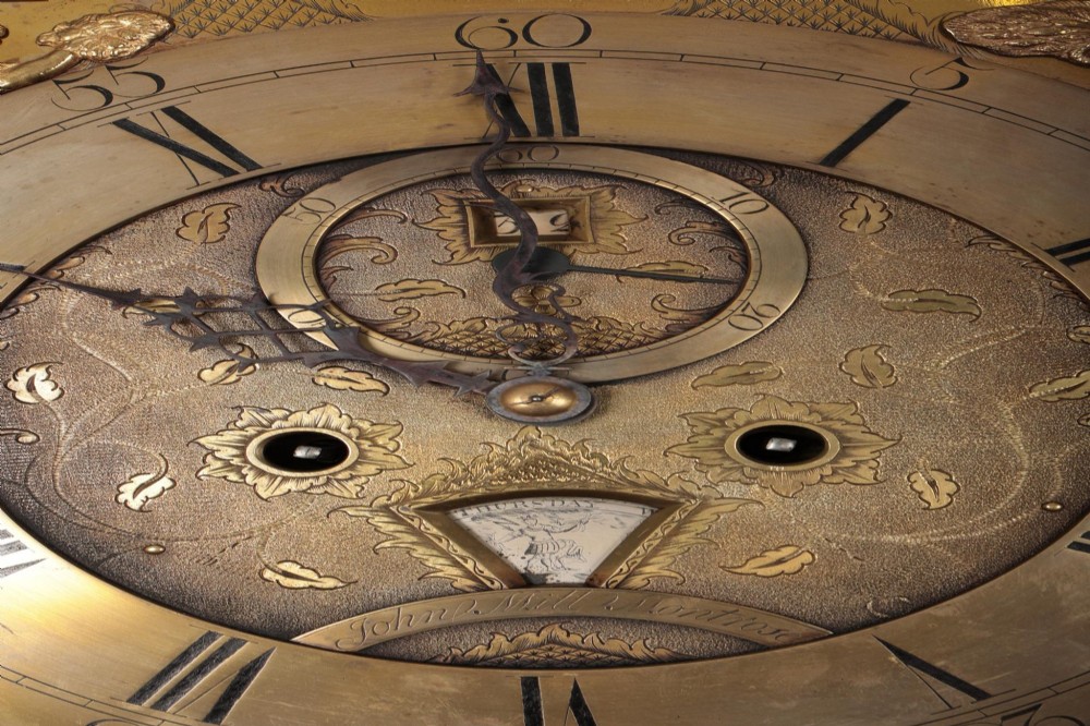 An antique Scottish painted satinwood longcase clock with an arched moonphase dial, brass finials, and neoclassical floral painted panels. View XII