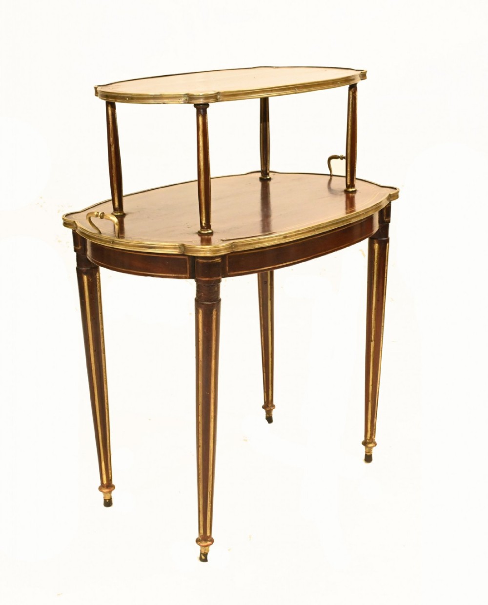 A two-tiered mahogany side table featuring shaped oval tops edged with brass galleries, slender turned legs, and brass side handles on the lower tier. View III