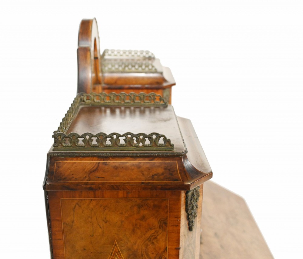 A 19th-century French walnut bonheur du jour desk featuring cabriole legs, a slant-front writing slope, and an upper superstructure with small glazed cabinets framing a central arched mirror. View V
