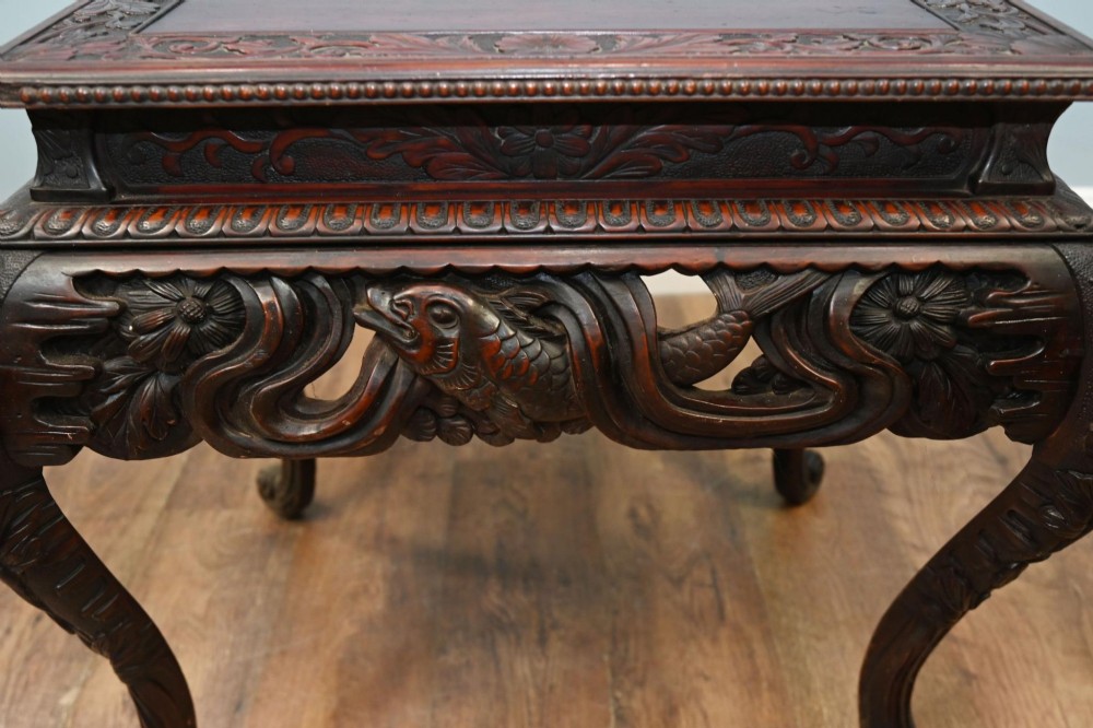 A dark brown antique Japanese side table featuring intricate relief carvings along the apron and cabriole legs. View VII