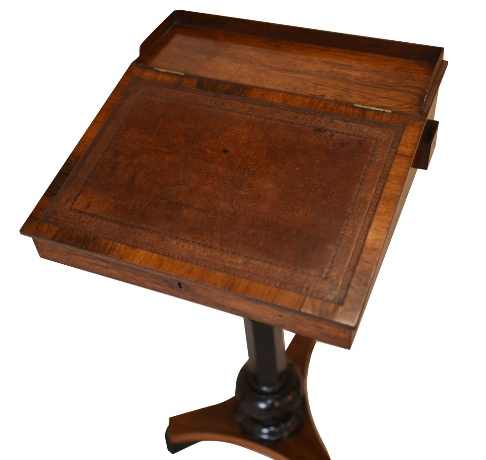 Victorian mahogany lectern desk featuring a sloped leather writing surface, turned ebonised pedestal, and triform base with scroll feet. View V