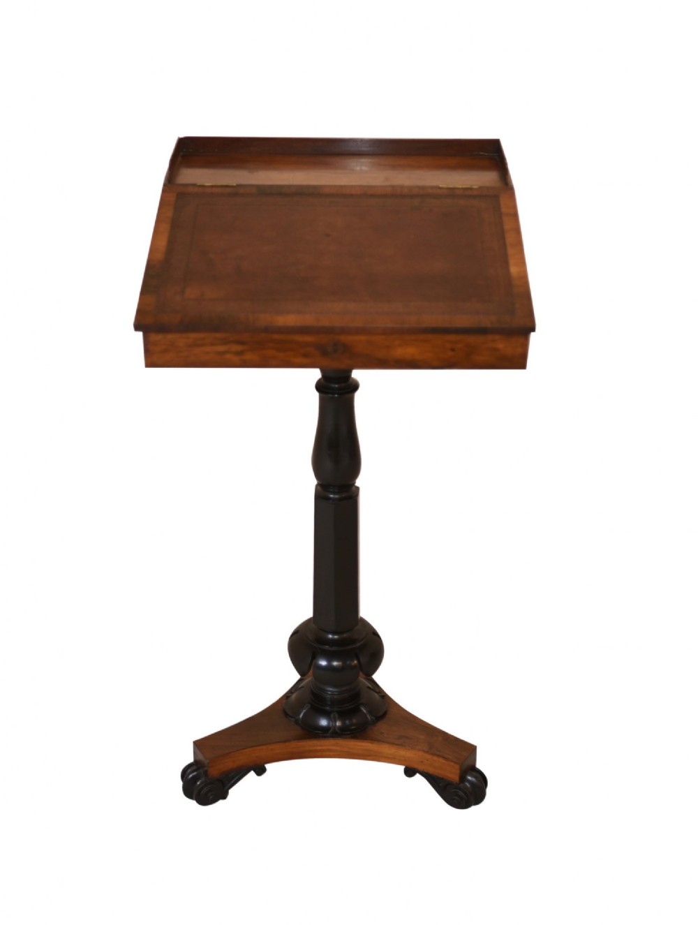 Victorian mahogany lectern desk featuring a sloped leather writing surface, turned ebonised pedestal, and triform base with scroll feet.