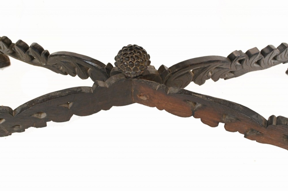 A late 19th-century Burmese dark teak console table featuring intricately pierced foliate carvings on the gallery back, skirt, and cross-stretcher, supported by legs carved as mythical figures. View XI