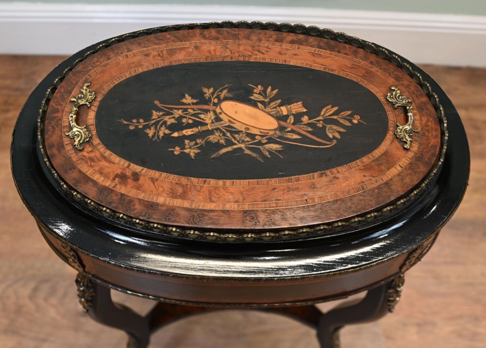 An antique French oval jardiniere table featuring amboyna wood veneer, floral marquetry, gilt-metal mounts, and ebonised cabriole legs. View VIII