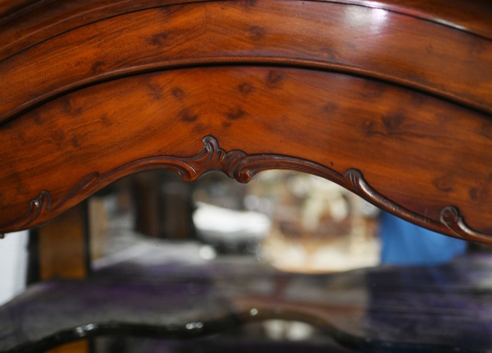 An antique French mahogany glazed vitrine cabinet featuring ornate cresting carvings, glass shelves, and carved cabriole legs. View IV
