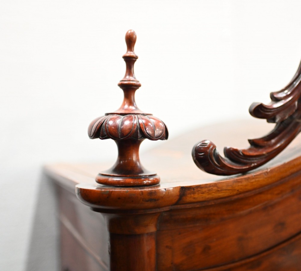 An antique French mahogany glazed vitrine cabinet featuring ornate cresting carvings, glass shelves, and carved cabriole legs. View VI