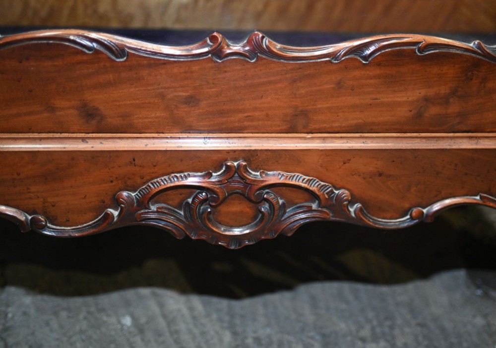 An antique French mahogany glazed vitrine cabinet featuring ornate cresting carvings, glass shelves, and carved cabriole legs. View IX