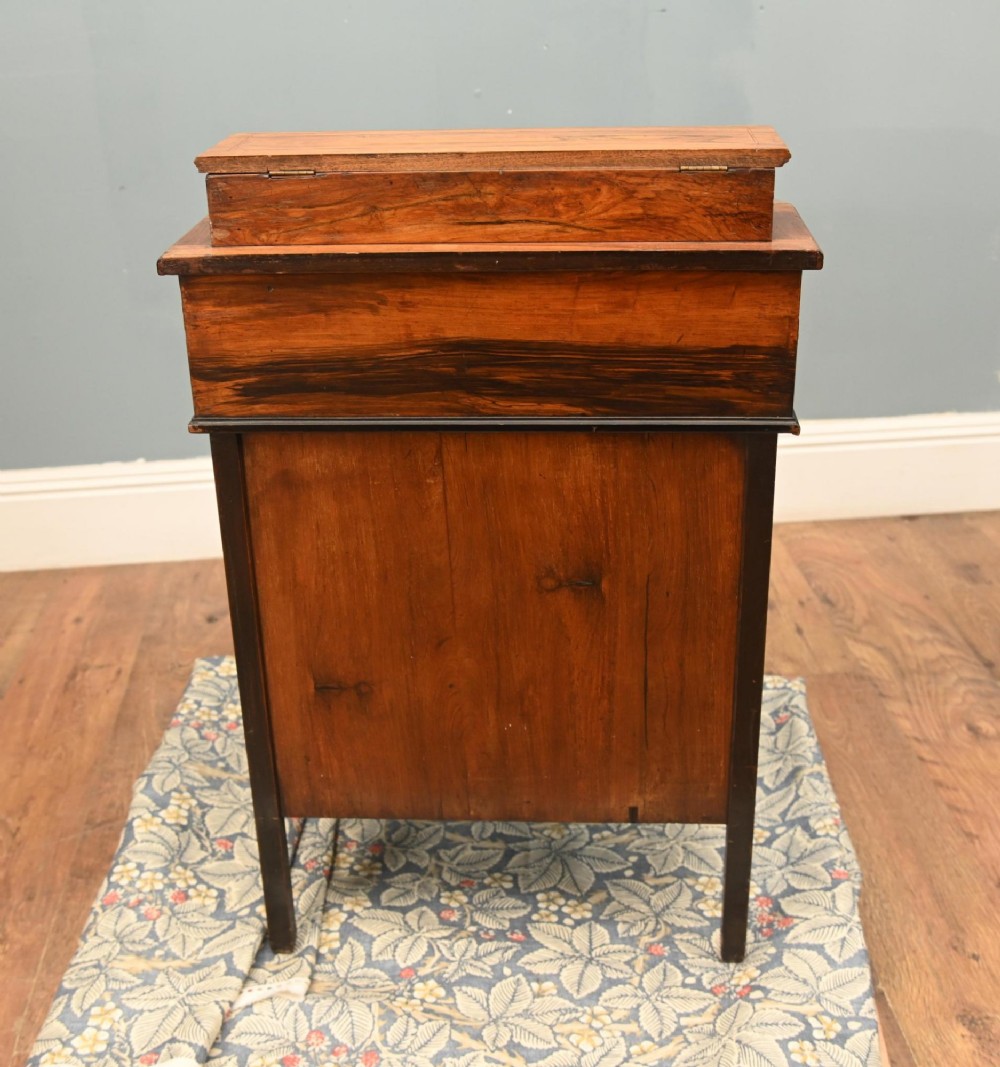 A late Victorian Sheraton Revival davenport desk crafted from warm brown wood, featuring decorative marquetry inlay and a dark leather inset writing surface. View IX