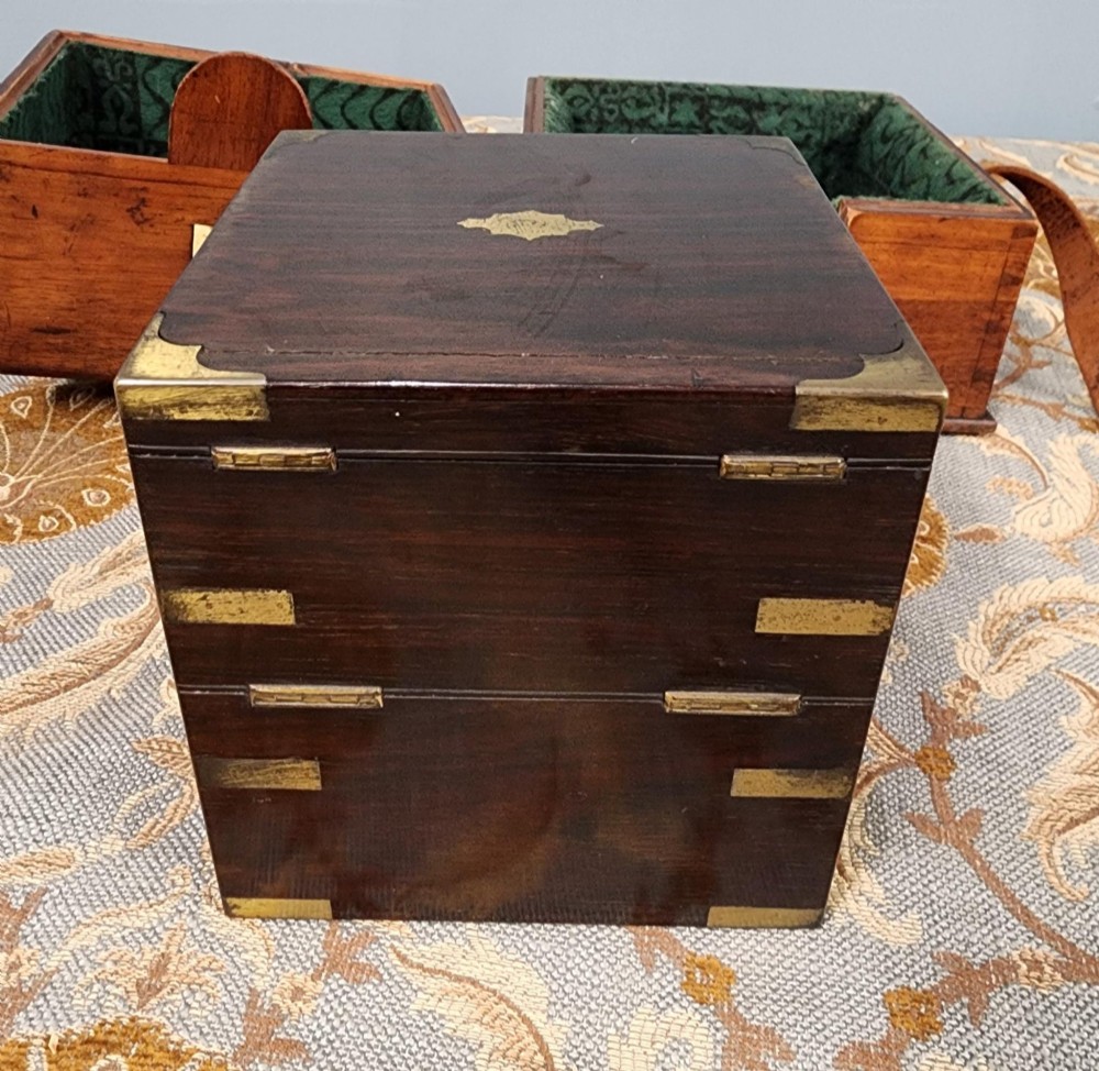 A Victorian brass marine chronometer mounted inside a brass-bound dark mahogany box with a printed manufacturer label. View VIII