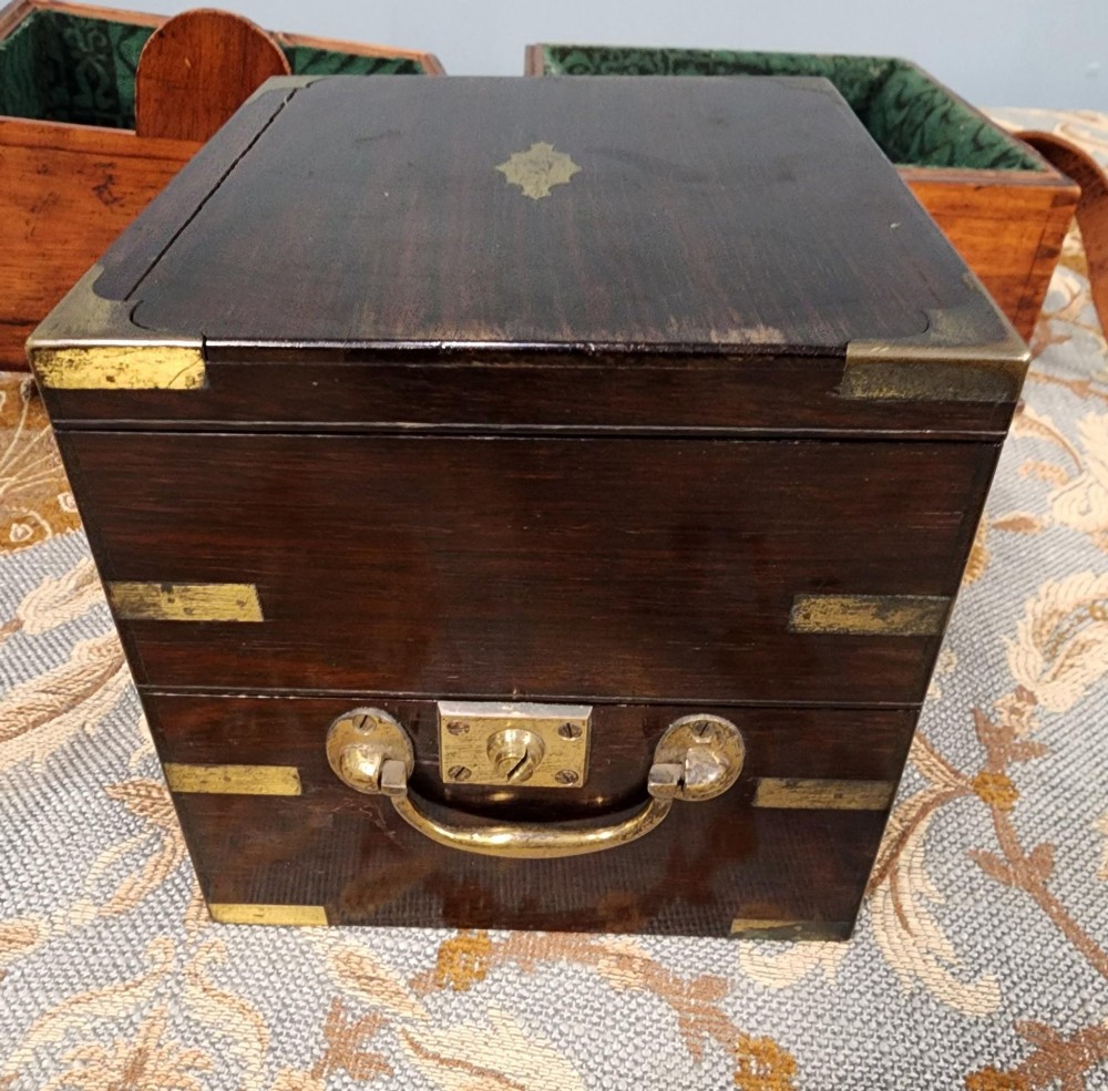 A Victorian brass marine chronometer mounted inside a brass-bound dark mahogany box with a printed manufacturer label. View IX