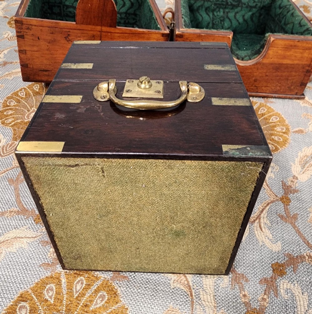 A Victorian brass marine chronometer mounted inside a brass-bound dark mahogany box with a printed manufacturer label. View X