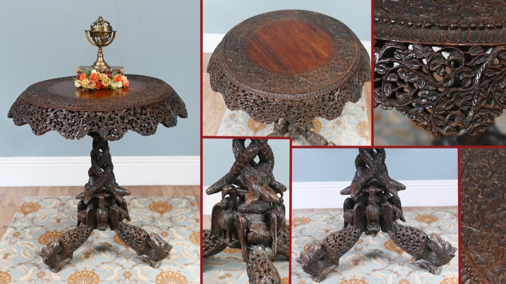 An antique dark hardwood Burmese side table with intricate pierced foliage carving around the circular top and a carved tripod base featuring mythological figure feet. View XIV