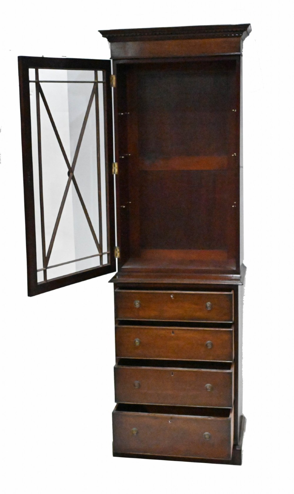A tall Georgian mahogany glazed bookcase featuring an astragal glass upper cabinet set above four graduated drawers with brass pull knobs. View VIII