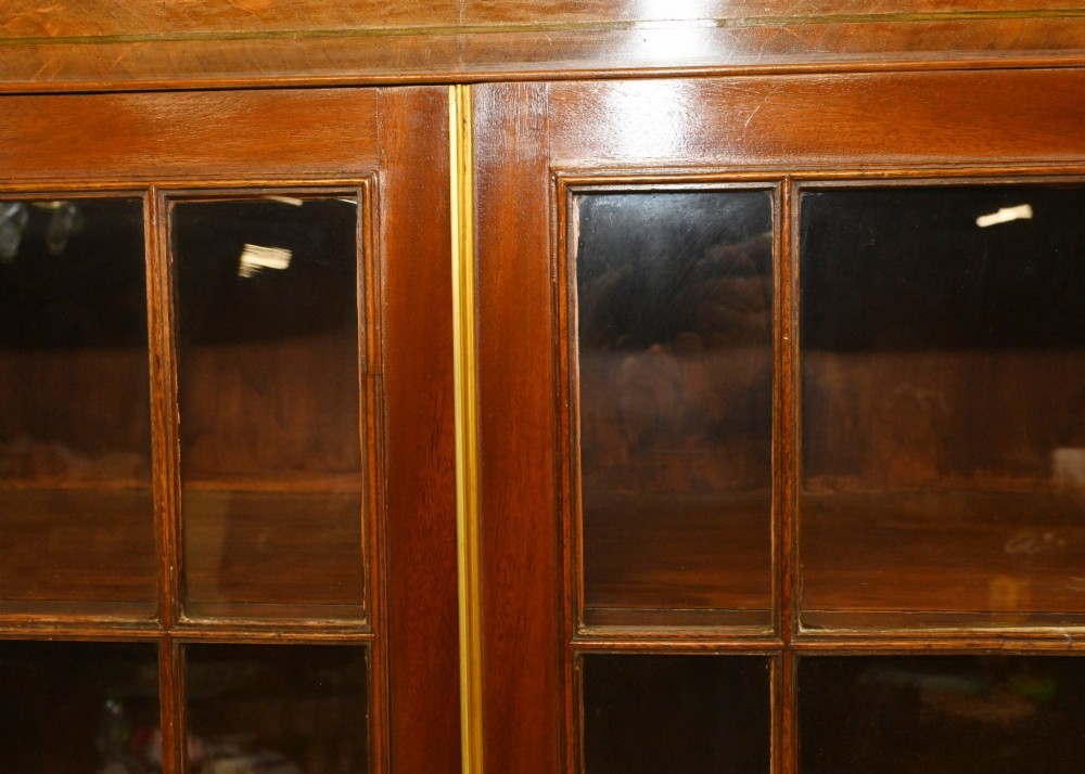 A Georgian mahogany secretaire bookcase featuring a glazed upper cabinet, a pull-out secretaire drawer with brass oval handles, and lower panelled doors. View II