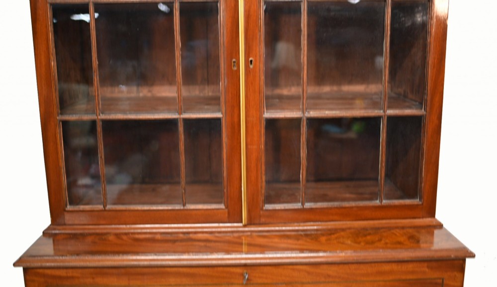 A Georgian mahogany secretaire bookcase featuring a glazed upper cabinet, a pull-out secretaire drawer with brass oval handles, and lower panelled doors. View III