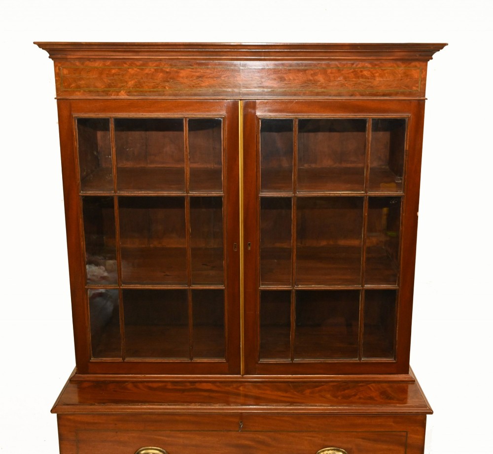 A Georgian mahogany secretaire bookcase featuring a glazed upper cabinet, a pull-out secretaire drawer with brass oval handles, and lower panelled doors. View IV