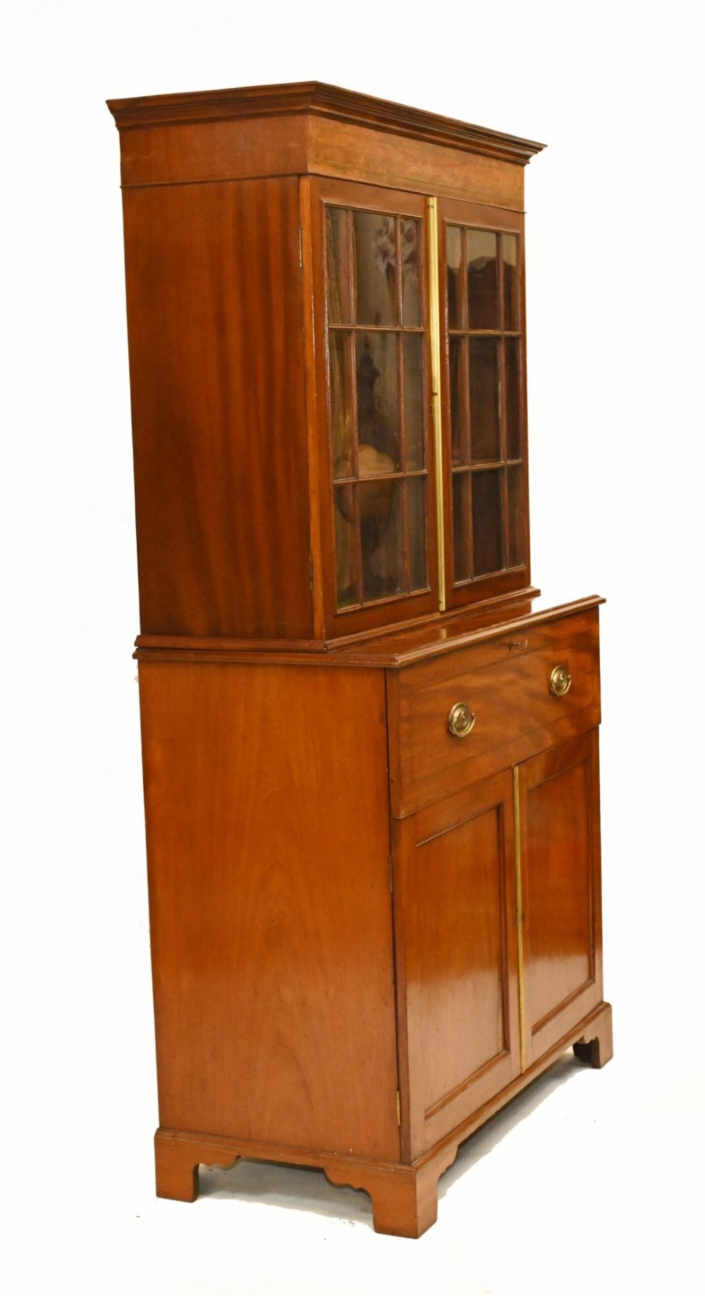 A Georgian mahogany secretaire bookcase featuring a glazed upper cabinet, a pull-out secretaire drawer with brass oval handles, and lower panelled doors. View VI