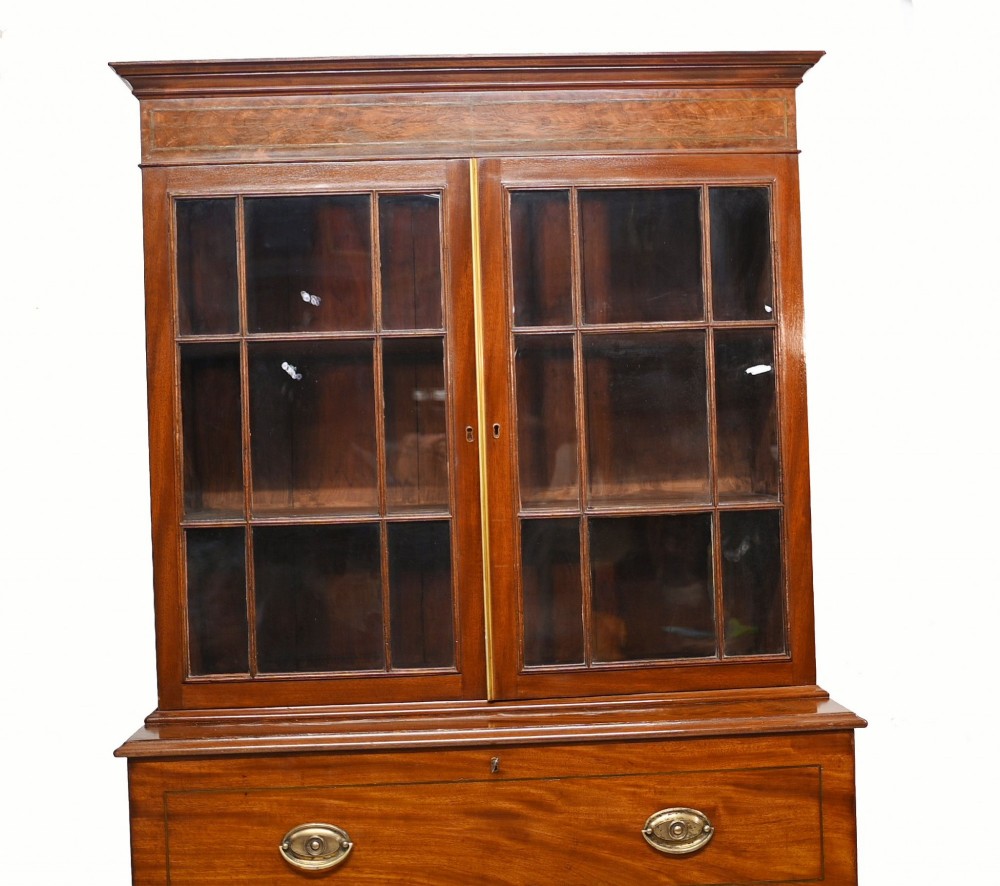 A Georgian mahogany secretaire bookcase featuring a glazed upper cabinet, a pull-out secretaire drawer with brass oval handles, and lower panelled doors. View XI
