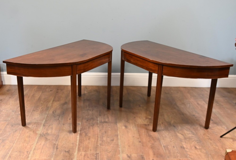 A pair of antique Georgian mahogany demi-lune console tables with semi-circular tops and straight tapered legs. View III