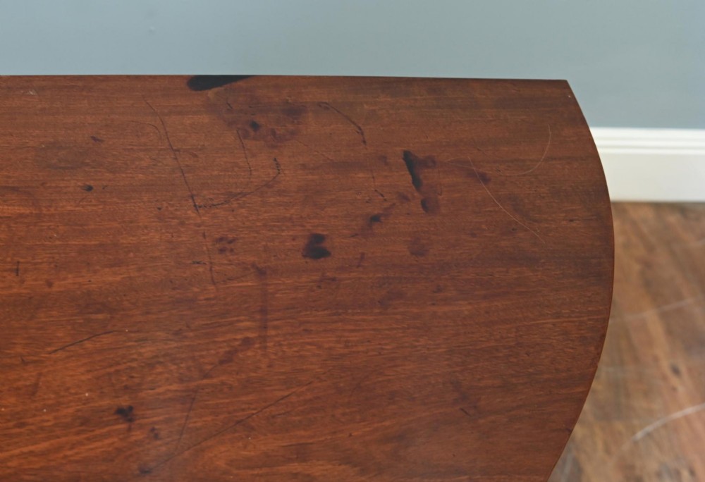 A pair of antique Georgian mahogany demi-lune console tables with semi-circular tops and straight tapered legs. View VI
