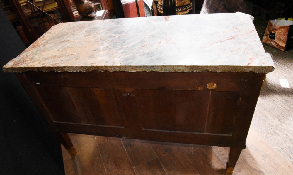 A French Empire style rosewood commode with a grey veined marble top, ornamental gilt bronze mounts, and square tapered legs with brass feet. View III