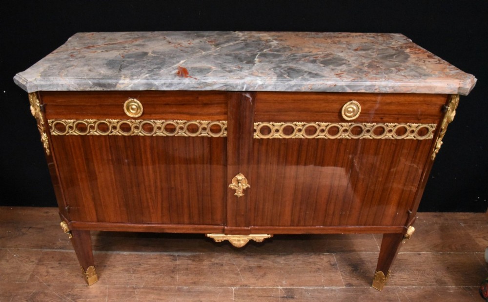 A French Empire style rosewood commode with a grey veined marble top, ornamental gilt bronze mounts, and square tapered legs with brass feet. View IV