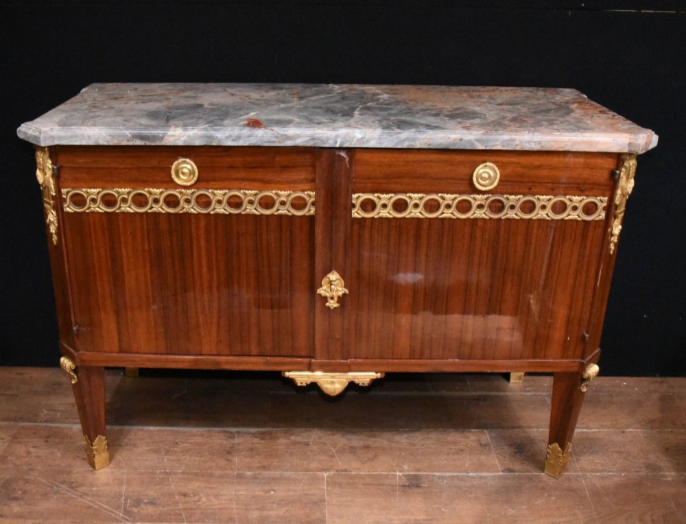 A French Empire style rosewood commode with a grey veined marble top, ornamental gilt bronze mounts, and square tapered legs with brass feet. View V