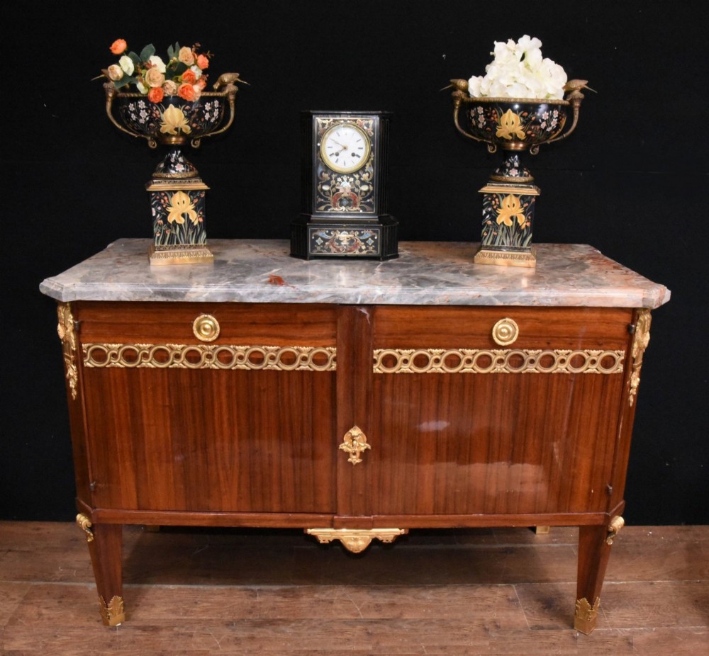 A French Empire style rosewood commode with a grey veined marble top, ornamental gilt bronze mounts, and square tapered legs with brass feet. View X