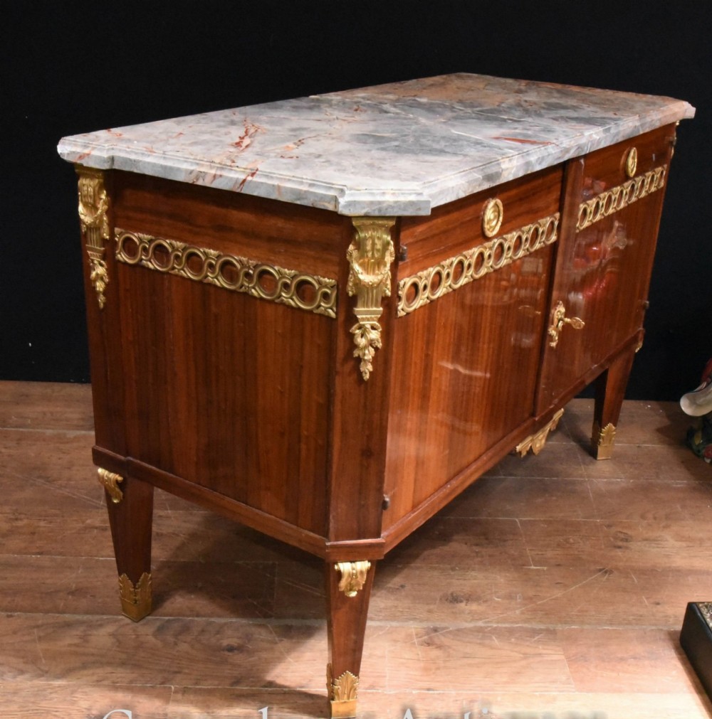 A French Empire style rosewood commode with a grey veined marble top, ornamental gilt bronze mounts, and square tapered legs with brass feet. View XIII