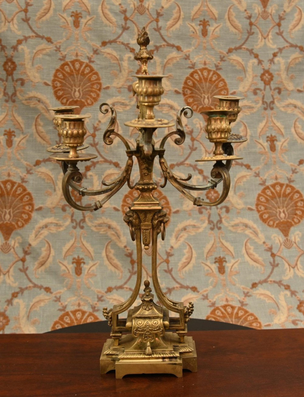 A 19th-century Louis XVI style gilt bronze clock garniture set comprising a central ornate mantel clock flanked by two matching five-light candelabras. View II